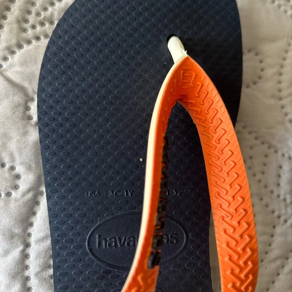 Havana’s flip flops size 29/30 (11-12). Navy base w/orange strap. Great shape!